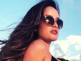 Hot brunette babe outdoors in her lingerie fingering herself